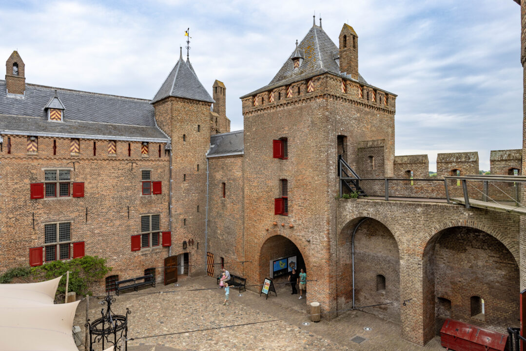 Het Muiderslot in de zomer. De lucht is licht bewolkt.